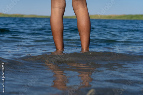 a boy in a lake standing