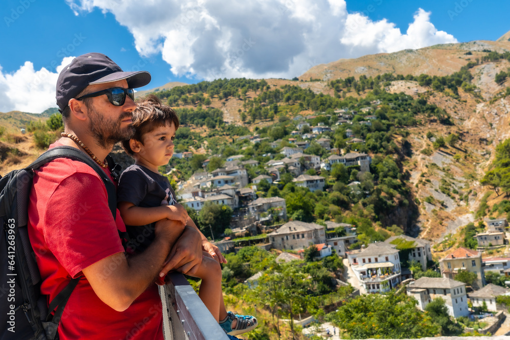 Naklejka premium A father with his son in the Ottoman Castle Fortress of Gjirokaster or Gjirokastra. Albanian