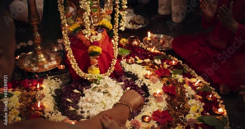 Hindu Religious Ceremony Traditions: Slow Motion of Group of People Burning Sages,Chanting and Giving Offerings to an Idol During Shiva Aarti Ritual in a Temple. Devoted Indian Worshipers Celebrating photo