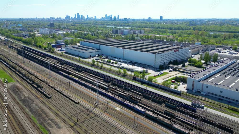 Flying above industrial railroad station with cargo trains and freight ...