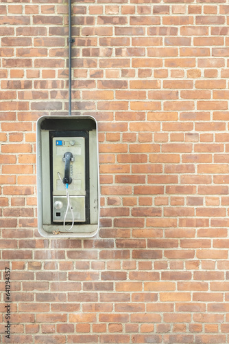 telephone booth on a brick wall background