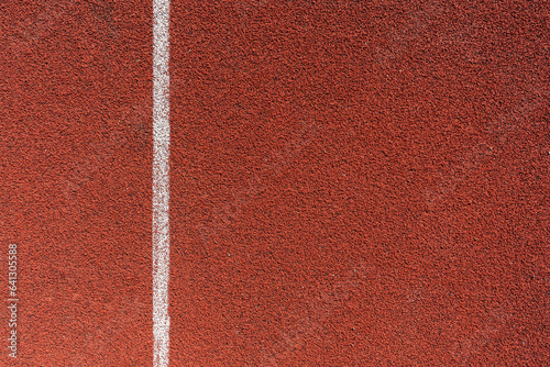 Running track surface with lanes and lines on a track and field athletics stadium. Sport running, jogging or walking runway.