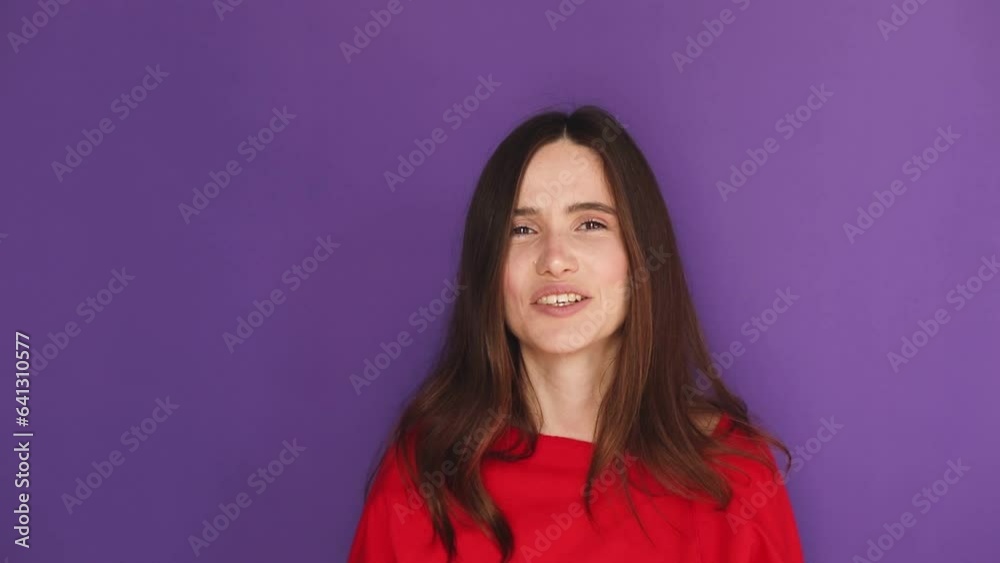 Young brunette lady wear red sweater is pointing at you by forefingers, winking and laughing posing on purple background. We need you, good choice, motivating encourage. Hey you! Young brunette lady wear red sweater is pointing at you by forefingers, winking and laughing posing on purple background. We need you, good choice, motivating encourage. Hey you!
