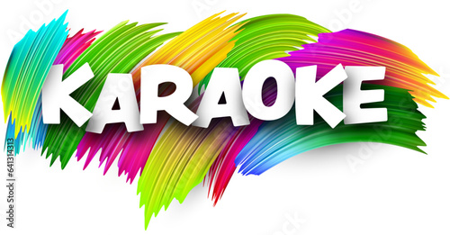 Karaoke paper word sign with colorful spectrum paint brush strokes over white.