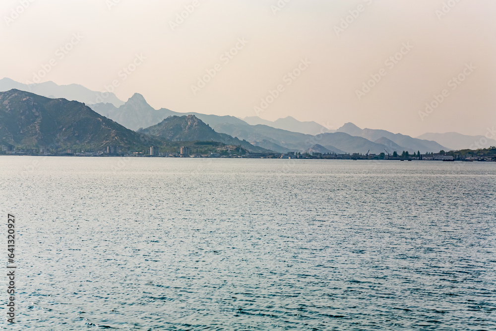 KUMGANGSAN TOURIST REGION, NORTH KOREA: Changjon town by the sea and Kumgang Mountains in the background KUMGANGSAN TOURIST REGION, NORTH KOREA: Changjon town by the sea and Kumgang Mountains in the background