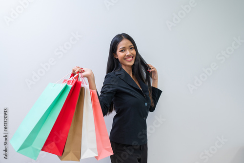 Happy beautiful woman showing shopping bags with goods, buying with discounts. 