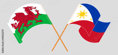 Crossed and waving flags of Wales and the Philippines