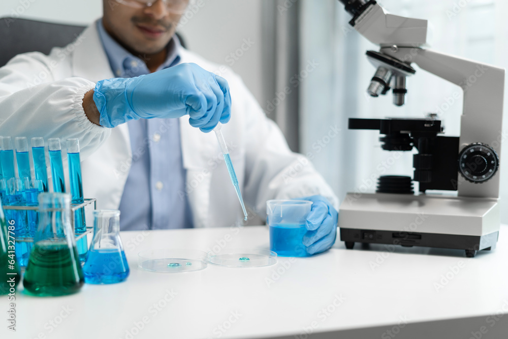 Science and medicine, scientist analyzing and dropping a sample into a glassware, experiments containing chemical liquid in laboratory on glassware, innovative and technology. Science and medicine, scientist analyzing and dropping a sample into a glassware, experiments containing chemical liquid in laboratory on glassware, innovative and technology.