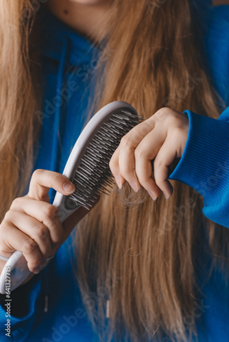 A girl with long hair combs her hair