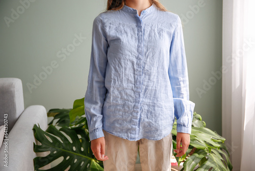 The woman wore a rumpled shirt. photo