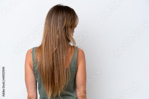 Young caucasian woman isolated on white background in back position and looking side