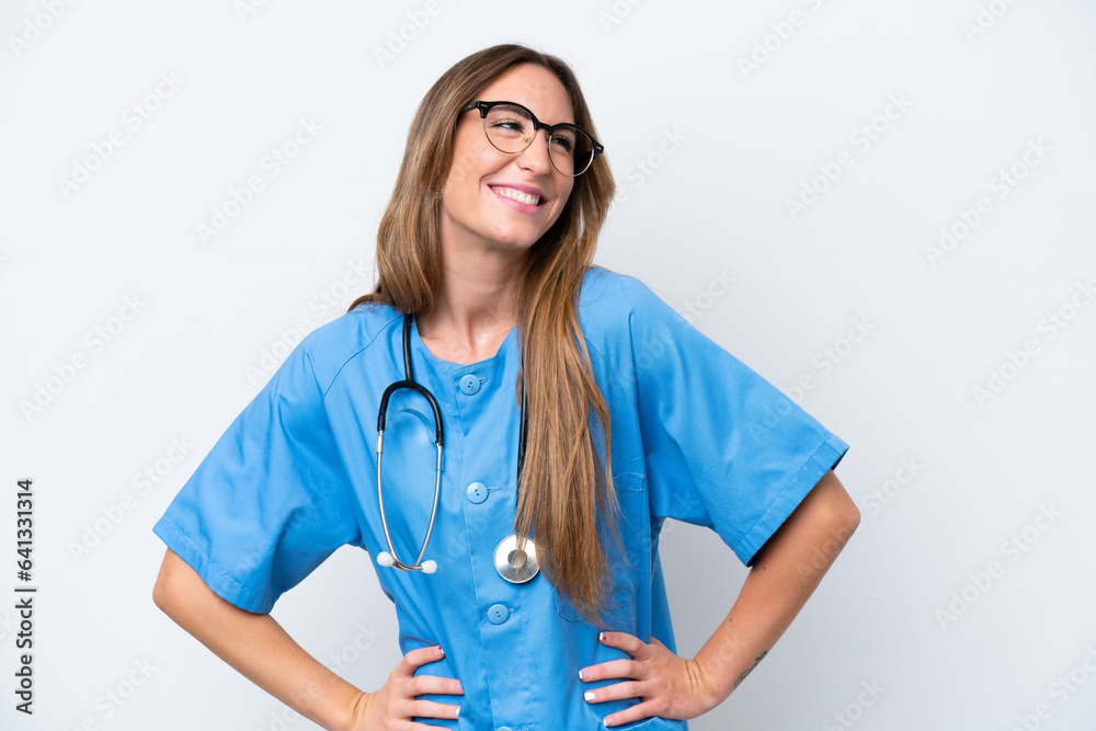 Young surgeon doctor woman isolated on blue background posing with arms at hip and smiling Young surgeon doctor woman isolated on blue background posing with arms at hip and smiling