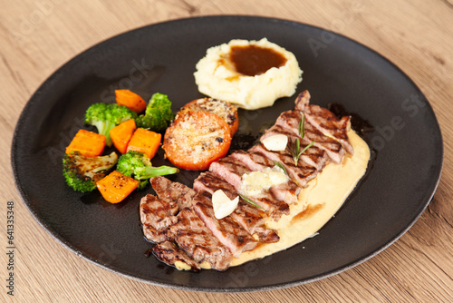 Striploin angus steak with mashed potato and grilled vegetable