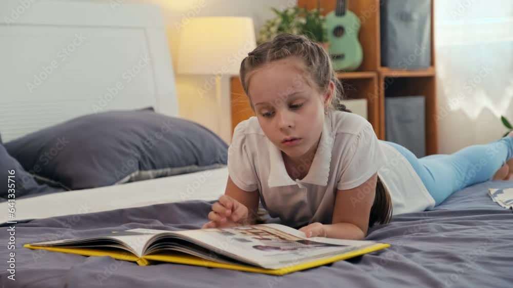 Pre-teen Caucasian girl watching big photo album while laying on bed of her room resting after long day at schoolPre-teen Caucasian girl watching big photo album while laying on bed of her room restin Pre-teen Caucasian girl watching big photo album while laying on bed of her room resting after long day at schoolPre-teen Caucasian girl watching big photo album while laying on bed of her room restin