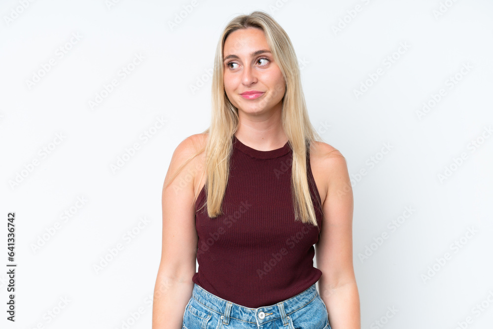 Young caucasian woman isolated on white background having doubts while looking side Young caucasian woman isolated on white background having doubts while looking side