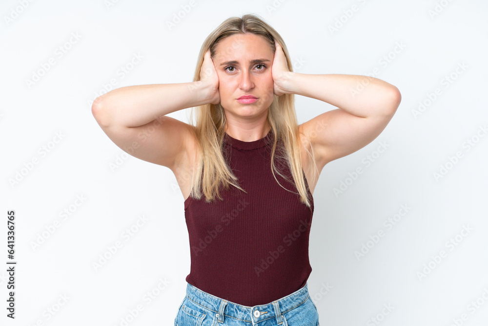 Young caucasian woman isolated on white background frustrated and covering ears