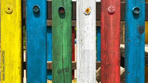 Bright, multi colorful fence on children's playground ,