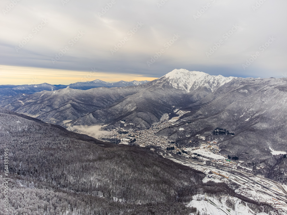 View of the winter sunset and snow-covered mountains in Sochi. High quality photo