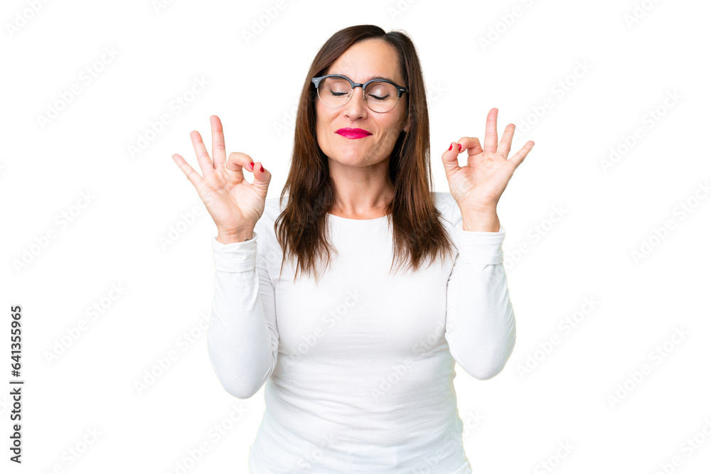 Middle age woman over isolated chroma key background in zen pose Middle age woman over isolated chroma key background in zen pose