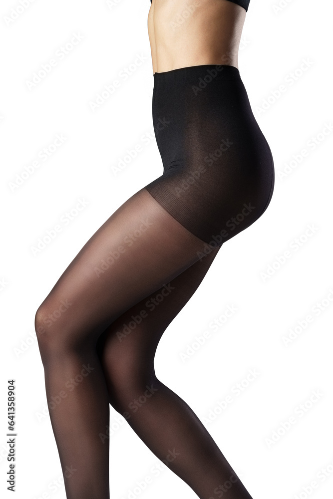 Legs of a woman in black capron tights on white background