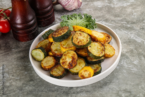 Roasted young zucchini in the plate