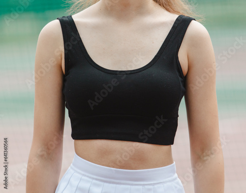 Black clothes topic on the girl's chest. Close-up