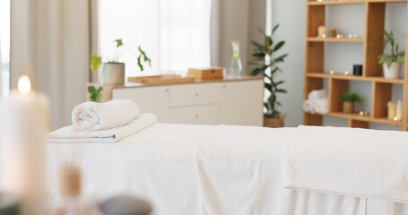 Foto auf Acrylglas Massagesalon Wellness, relax and a massage table on an empty spa background for luxury wellness or treatment. Health, zen and hospitality with candles for peace or aromatherapy a room of a modern beauty salon  © Nina L/peopleimages.com