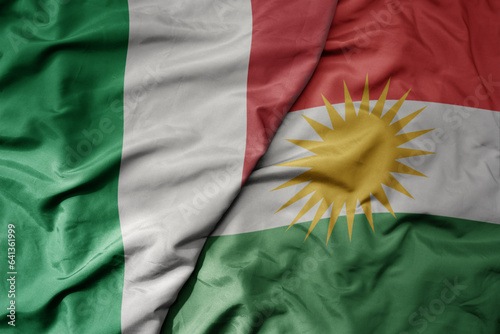 Bild auf Leinwand big waving national colorful flag of italy and national flag of kurdistan