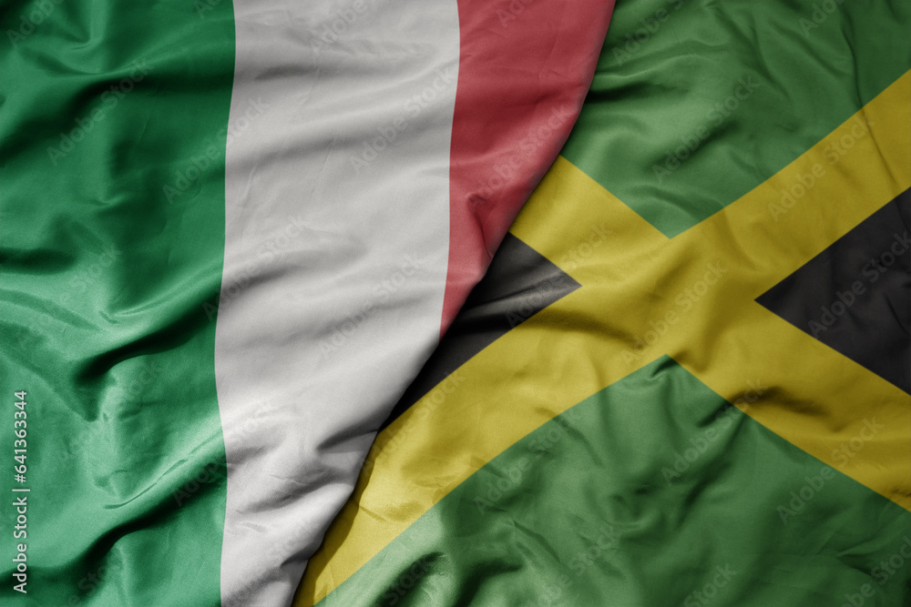 Obraz premium big waving national colorful flag of italy and national flag of jamaica .