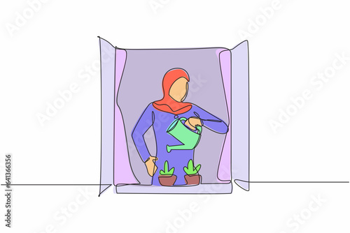 Single one line drawing active Arab woman watering flowers on the balcony. Young lady doing gardening favorite hobby. Home garden, house plants growing. Continuous line draw design vector illustration
