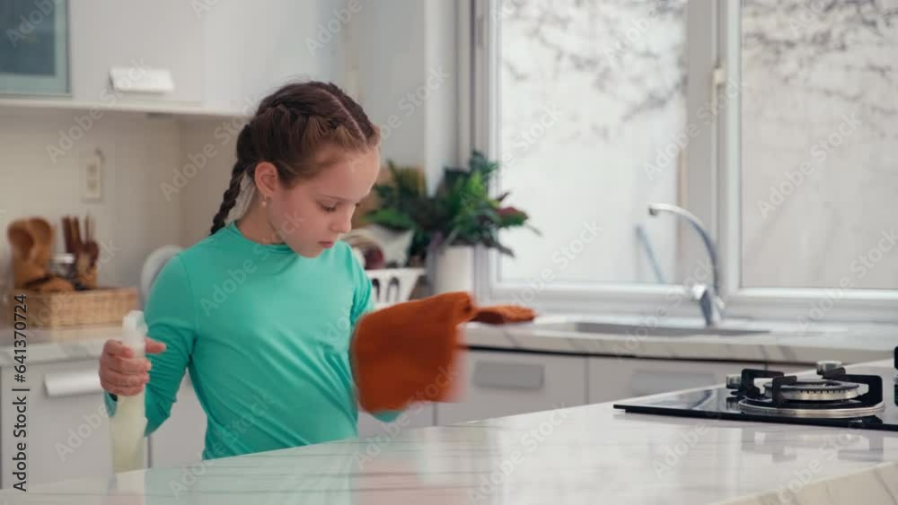 Medium shot of pre-teen Caucasian girl wiping table with rag and detergent at kitchen aloneMedium shot of pre-teen Caucasian girl wiping table with rag and detergent at kitchen aloneMedium shot of pre