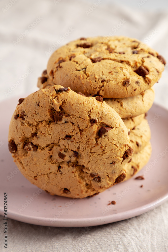 Homemade Cookies with Milk Chocolate Chunks on a Plate, side view. Close-up. Homemade Cookies with Milk Chocolate Chunks on a Plate, side view. Close-up.