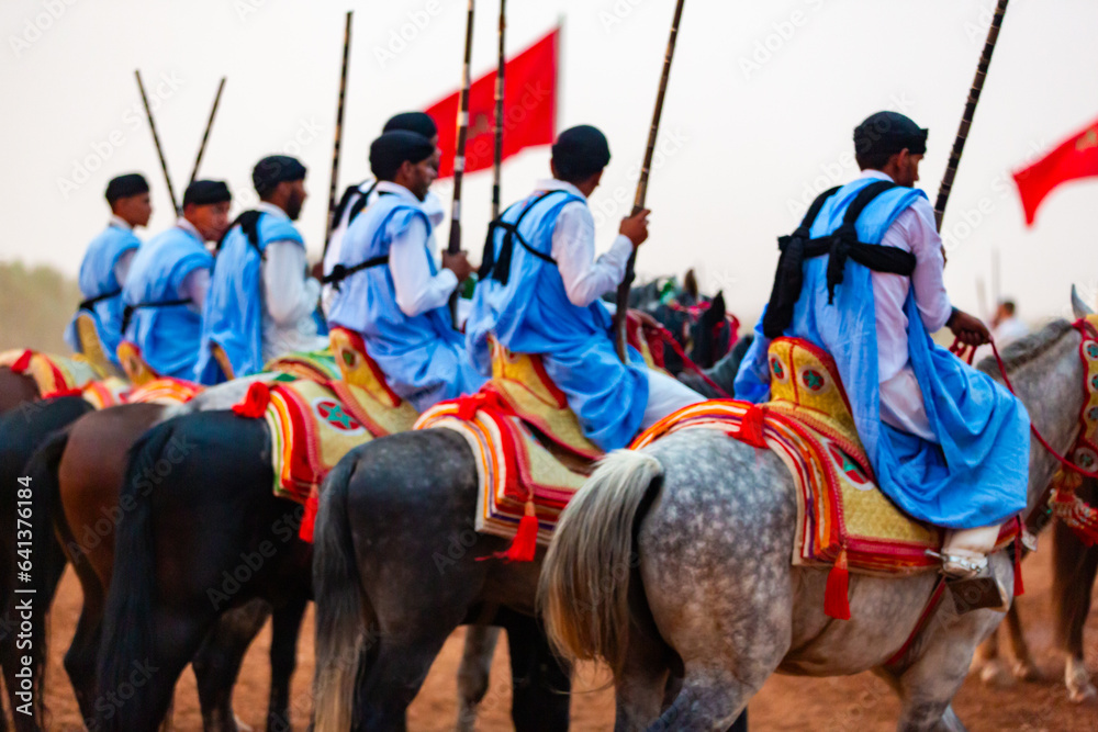 Equestrians participating in a traditional fancy dress event named Tbourida in Arabic dressed in a traditional Moroccan outfit and accessories of the knights