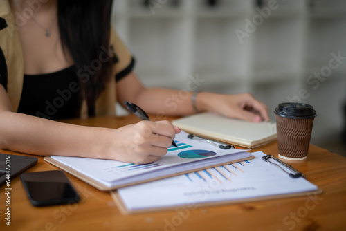 Cropped image of businesswoman analyzing business results by exploring trends of popular products in the market
