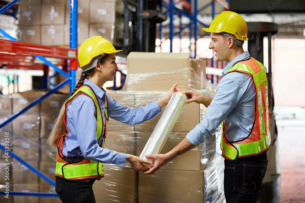 factory workers or warehouser wrapping stretch film parcel on pallet covered cardboard boxed in warehouse storage factory workers or warehouser wrapping stretch film parcel on pallet covered cardboard boxed in warehouse storage