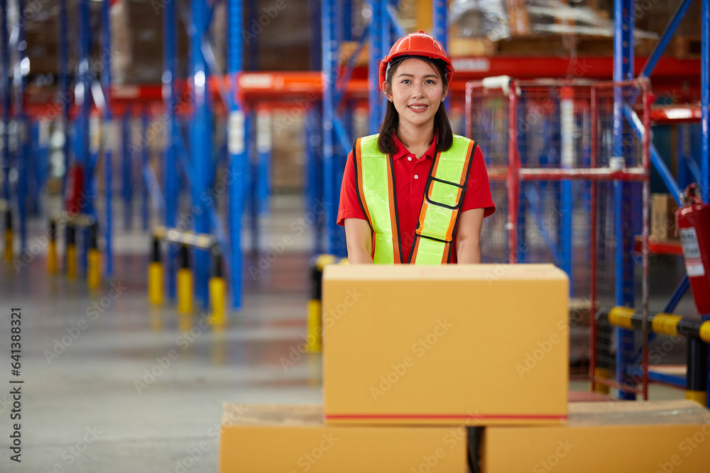 worker pushing cart with corrugated boxes in the warehouse storage