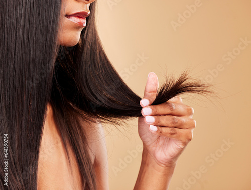 Hair, split ends and damage with woman, beauty and keratin treatment fail on studio background. Dry, salon hairstyle mistake and haircare with texture, growth and cosmetic care with breakage