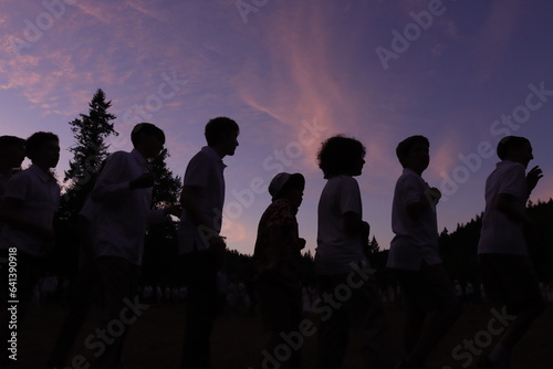 Shilloute of Campers Dancing at Sunset photo