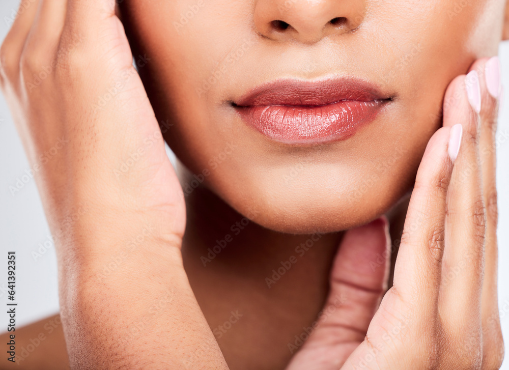 Fototapeta premium Face, hands and mouth with a woman closeup in studio on a white background for beauty, skincare or natural cosmetics. Aesthetic, lips and wellness with a young model touching her healthy skin