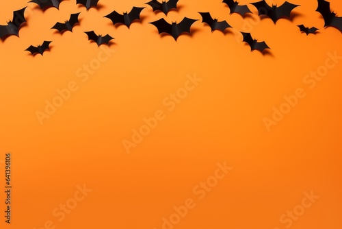 Halloween composition - black bats on orange background  copy space  top view  greeting card  design mock up