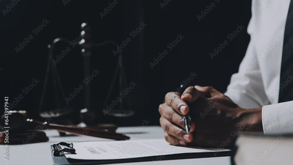 Business and lawyers discussing contract papers with brass scale on desk in office. Law, legal services, advice, justice and law concept picture with film grain effect Business and lawyers discussing contract papers with brass scale on desk in office. Law, legal services, advice, justice and law concept picture with film grain effect