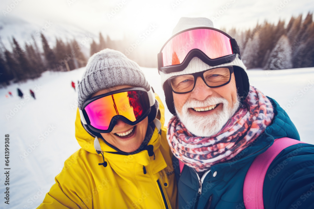 Happy elderly couple with sunglasses and ski equipment in ski resort Bukovel, having fun and taking selfie, winter holiday concept