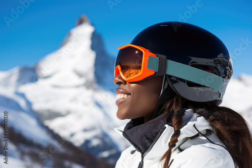 Young black woman wearing sunglasses and ski equipment in ski resort on Matterhorn, winter holiday concept. © Jasmina