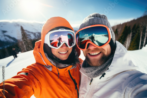 Happy young couple with sunglasses and ski equipment in ski resort Bukovel, having fun and taking selfie, winter holiday concept