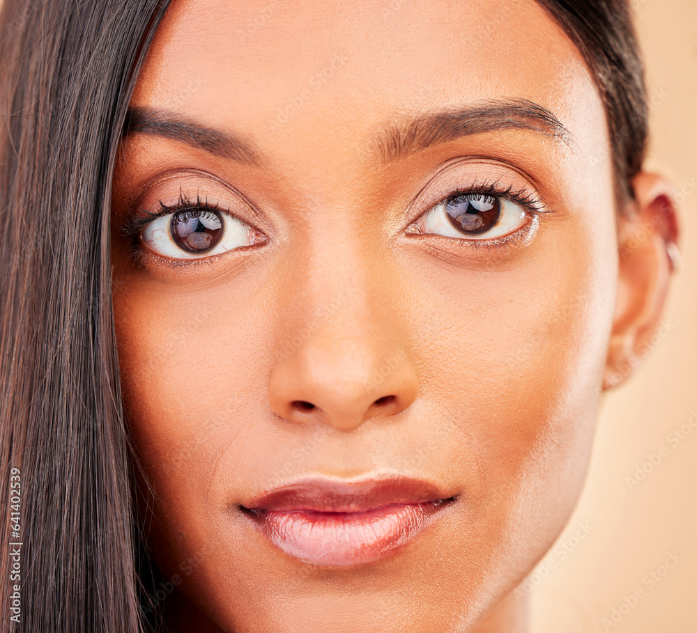 Beauty, makeup and portrait of woman in a studio with self care, glamour and face routine. Health, cosmetic ad headshot of young Indian female model with facial cosmetology by brown background. Beauty, makeup and portrait of woman in a studio with self care, glamour and face routine. Health, cosmetic ad headshot of young Indian female model with facial cosmetology by brown background.
