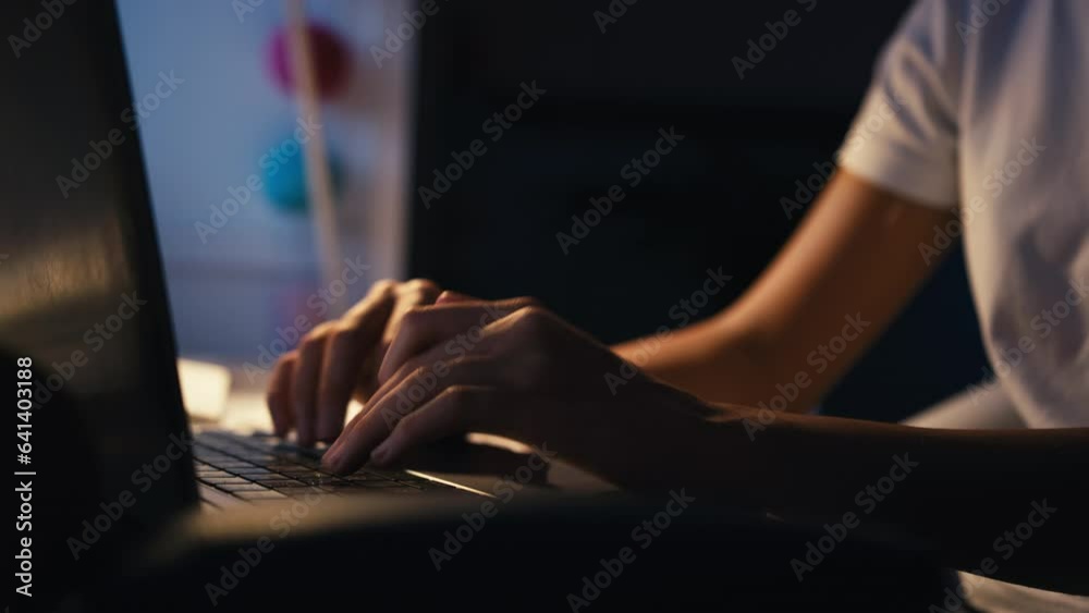 Close up of teenage girl studying at home with laptop in bedroom desk at night - shot in slow motion