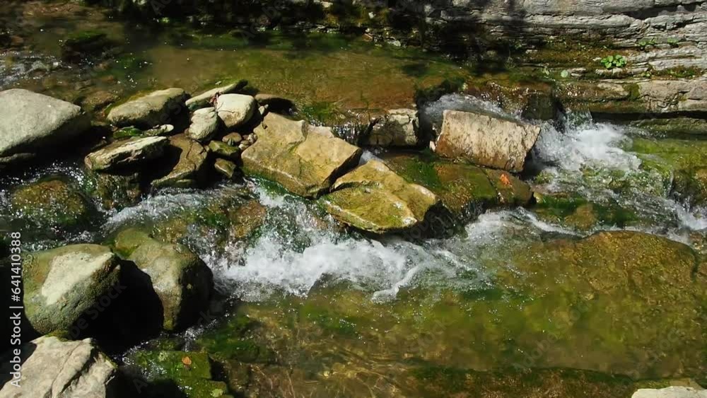 The rapids on the river. Mountain river flowing through the green forest. Stream in the wood. Small river flowing rapidly and vividly through its wild stony valley. Stormy rifts on a mountain river. The rapids on the river. Mountain river flowing through the green forest. Stream in the wood. Small river flowing rapidly and vividly through its wild stony valley. Stormy rifts on a mountain river.