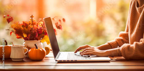 Woman typing on laptop in Autumn. Autumn pumpkins with using a laptop computer from above, digital ai 