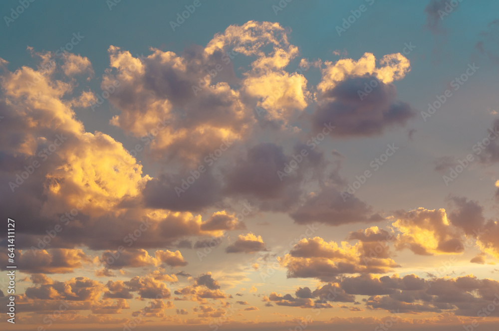 Sunset sky at sea with colorful clouds. Abstract nature background. Dramatic blue sky with orange colorful sunset clouds in twilight time Sunset sky at sea with colorful clouds. Abstract nature background. Dramatic blue sky with orange colorful sunset clouds in twilight time