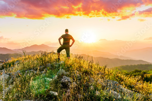 man doing hiking sport in mountains with anazing highland view © Yaroslav